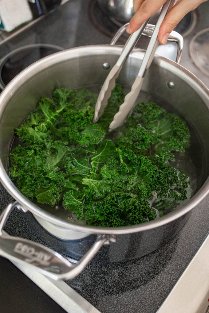 tongs and kale with pot