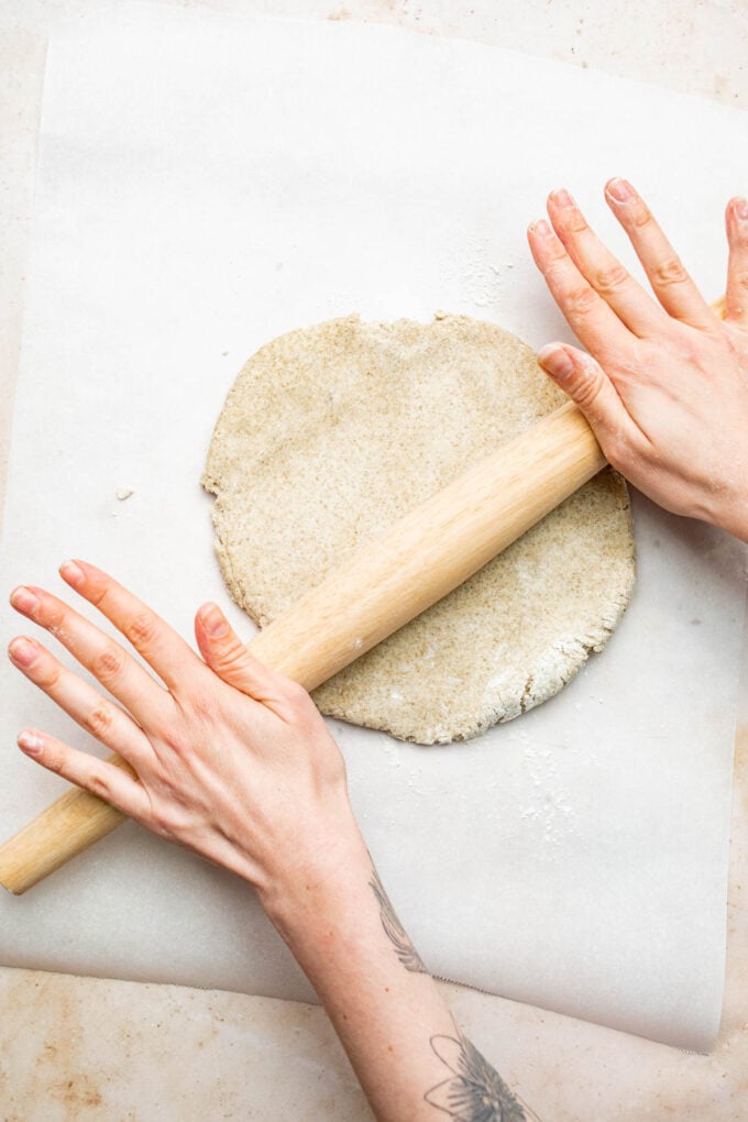hand rolling out dough